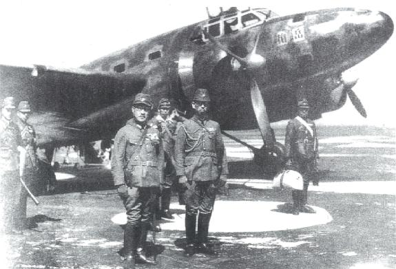 Marquis Maeda (left foreground) with the Yae Dake, the twin engine Mitsubishi aircraft in which he flew to Sarawak, that had been the first Japanese aircraft to cross the Pacific to America non stop. 