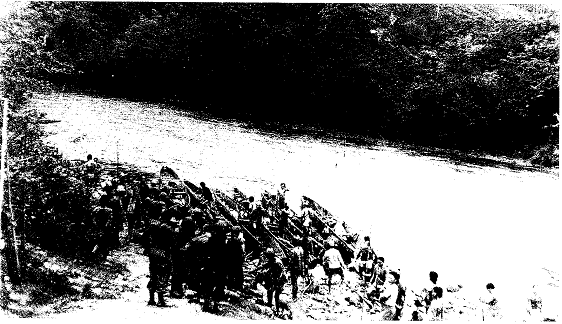 Men of Semut II embarking native perahu canoes at Long Akah to go down the Baram River to attack the Japanese